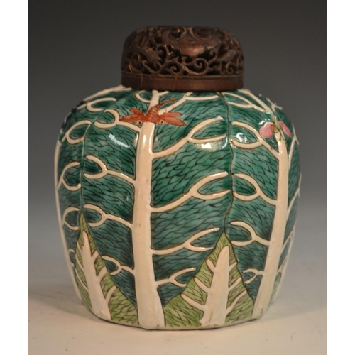 298 - A Chinese porcelain ovoid ginger jar, of small proportions, moulded in relief and picked out in two ... 