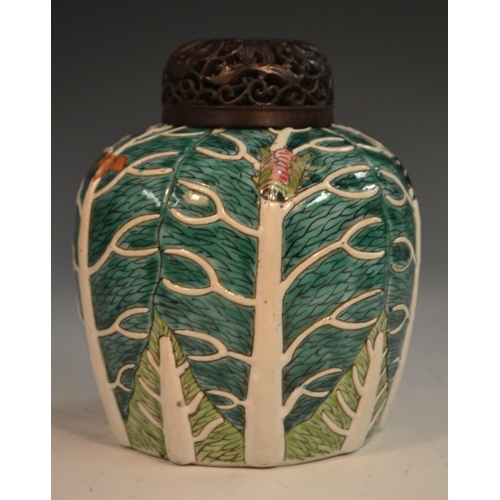 298 - A Chinese porcelain ovoid ginger jar, of small proportions, moulded in relief and picked out in two ... 