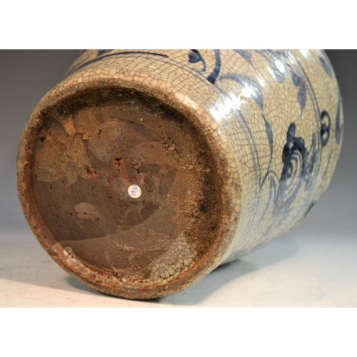 304 - A Chinese Zhangzhou or Swatow ware baluster wine jar, the crackle ground painted in underglaze blue ... 