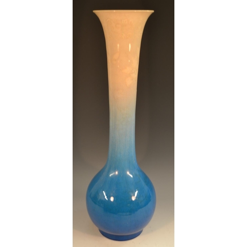 314 - A large Japanese Awaji trumpet shaped bottle vase, glazed in graduating tones of pale blue and cream... 