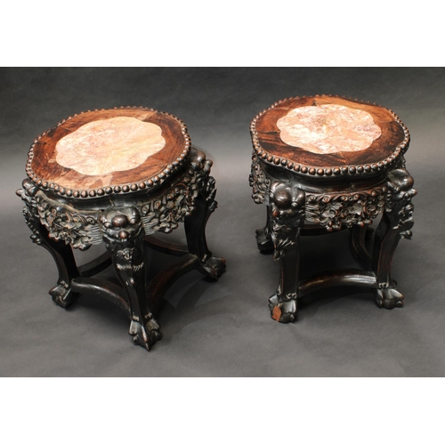 318 - A pair of 19th century Chinese hardwood jardiniere stands, each shaped circular top with inset soaps... 