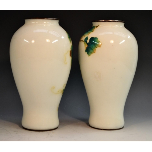 323 - A pair of Japanese cloisonné baluster vases, enamelled with fruiting vine, silver coloured metal mou... 