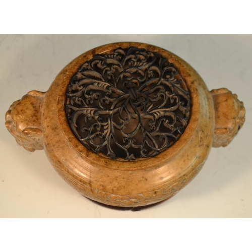 341 - A Chinese brown soapstone ding censer, the sides carved in relief with a ferocious dragon, the proje... 