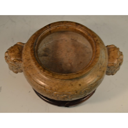 341 - A Chinese brown soapstone ding censer, the sides carved in relief with a ferocious dragon, the proje... 