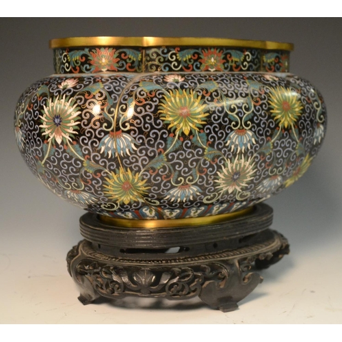 342 - A Chinese cloisonné lobed ovoid jardiniere, profusely decorated in polychrome with lotus, flowers an... 