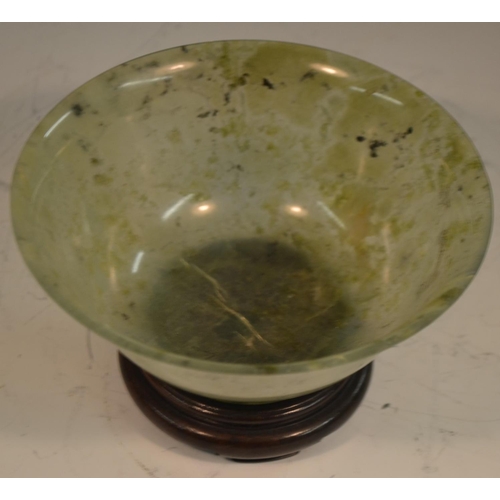 345 - A Chinese green jade flared circular bowl, quite plain, 12.5cm diam, hardwood stand