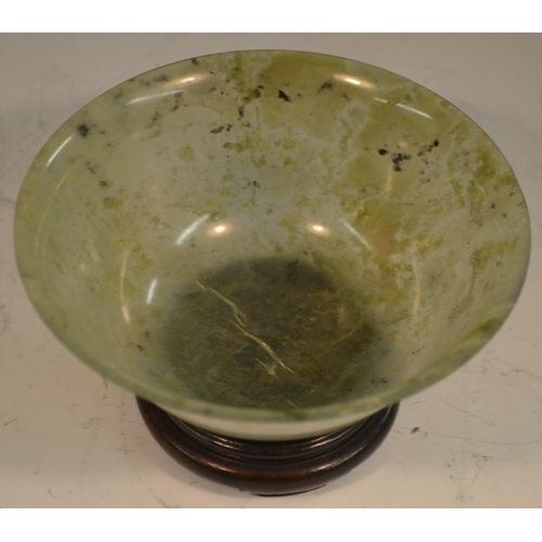 345 - A Chinese green jade flared circular bowl, quite plain, 12.5cm diam, hardwood stand