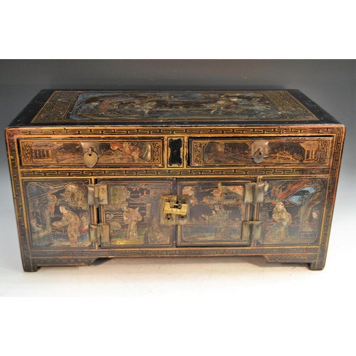 348 - A Chinese low cabinet, of two drawers above cupboard doors,  painted with figures on a black ground,... 