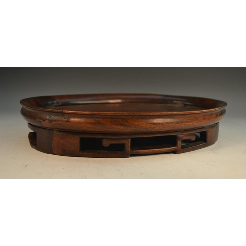 355 - A large Chinese hardwood table top stand, dished top above a deep frieze pierced with trellis, 37cm ... 