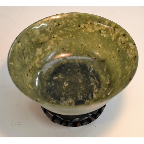 358 - A spinach jade bowl, 12cm diam, on  stand