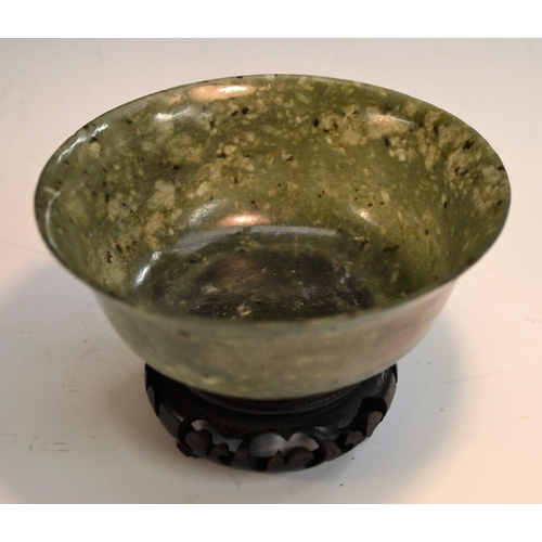 358 - A spinach jade bowl, 12cm diam, on  stand