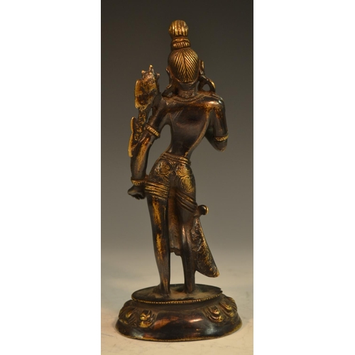 369 - Indian School, a dark and gilt patinated bronze, of Bhumi Devi, the Earth Goddess, her hand raised i... 