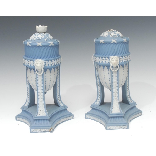 57 - A pair of Wedgwood blue jasper cassolettes, the ovoid bowls applied white relief with stiff leaves, ... 