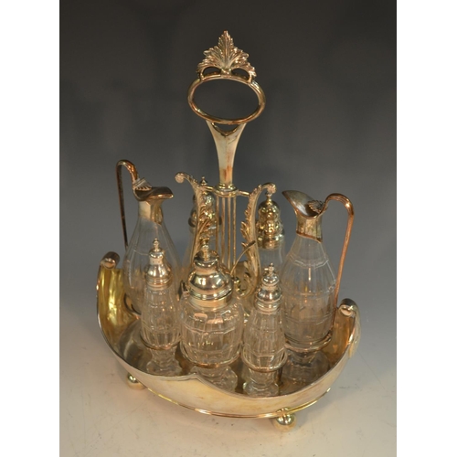 574 - A George III Old Sheffield Plate boat shaped seven bottle cruet, lyre shaped posted handle, facet-cu... 