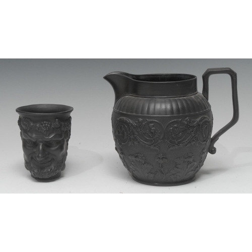 58 - A Wedgwood black basalt Bacchus cup, with vine chaplet, 10cm high, a similar black basalt jug, mould... 