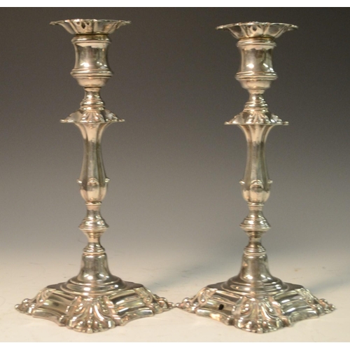 580 - A pair of George II Revival E.P on copper candlesticks, drilled as table lamps, shells to angles, 25... 