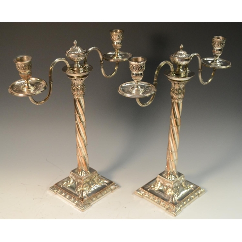 581 - A pair of George III Neo-Classical Old Sheffield Plate two-light, two-branch table candelabra, urnul... 