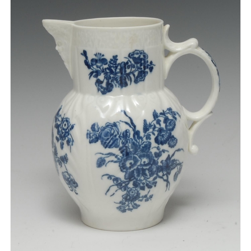 60 - A Caughley cabbage leaf moulded mask jug, printed in underglaze blue with flower sprays, C-scroll ha... 