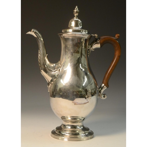 681 - A George III provincial silver coffee pot, hinged lofty domed cover with urn finial, scroll-capped f... 