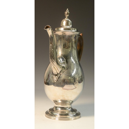 681 - A George III provincial silver coffee pot, hinged lofty domed cover with urn finial, scroll-capped f... 