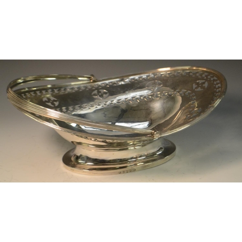 688 - A George III silver boat shaped swing-handled cake basket, pierced and bright-cut engraved with a br... 