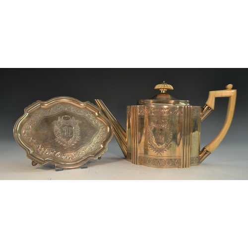 695 - A George III silver commode shaped teapot and stand, bright-cut engraved and outlined throughout wit... 