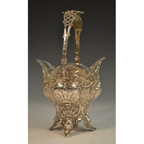 729 - A German silver ogee shaped  sweetmeat basket, pierced and embossed with scrolls and foliage, swing ... 