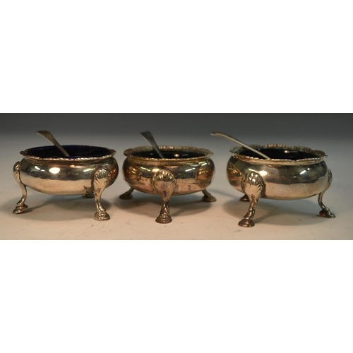 749 - A matched set of three early George III silver cauldron salts, hoof feet, 6cm diam, various dates an... 