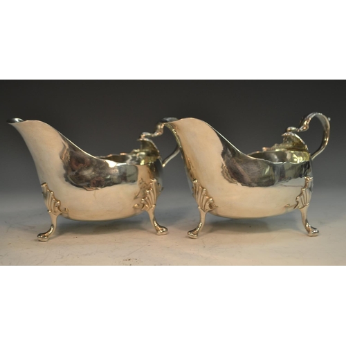 756 - A pair of George III Irish sauce boats, acanthus capped double scroll handles, shaped pad feet with ... 