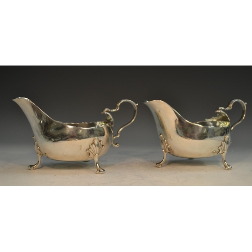 756 - A pair of George III Irish sauce boats, acanthus capped double scroll handles, shaped pad feet with ... 