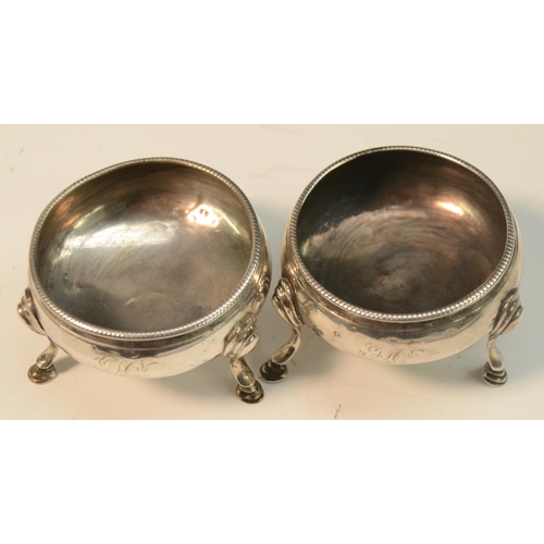 758 - A pair of George III silver cauldron salts, milled borders, hoof feet, 6cm diam, London 1784