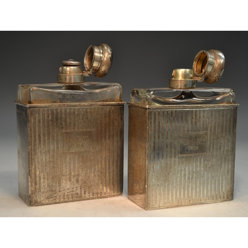 762 - A pair of George V silver slip-cased flasks, hinged domed covers, engine turned in bands, 12.5cm hig... 