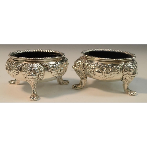 769 - A pair of substantial George II silver cauldron salts, cast and applied with flowering swags and bol... 