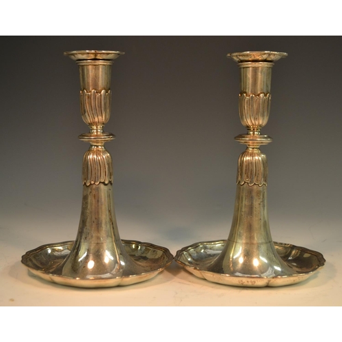 770 - A pair of Swiss silver candlesticks, detachable nozzles, dished trumpet shaped bases with shaped bor... 