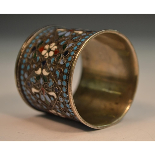 777 - A Russian silver and cloisonne enamel napkin ring, brightly decorated in polychrome, 4cm long, c.190... 