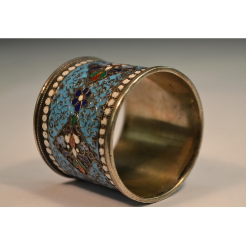 778 - A Russian silver and cloisonne enamel napkin ring, brightly decorated in polychrome, white 'jewelled... 