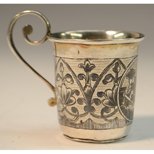 783 - A Russian silver and niello vodka cup, decorated with a topographical vignette, scroll handle, gilt ... 