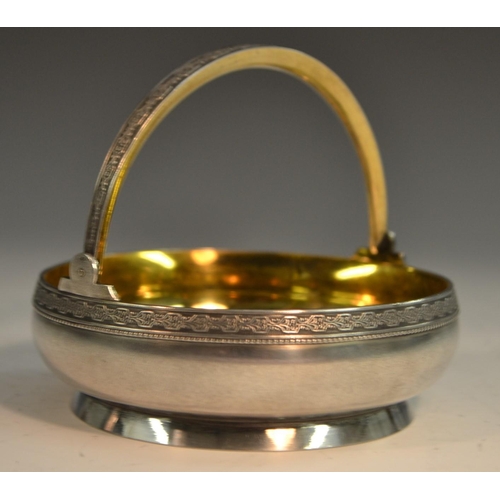 784 - A Russian silver circular swing-handled basket, gilt interior, 10.5cm wide, 875 standard