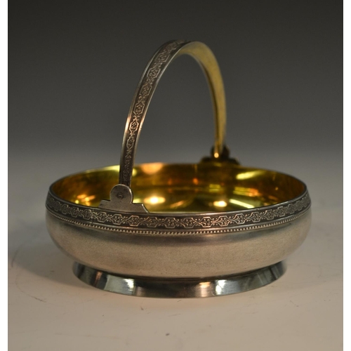 784 - A Russian silver circular swing-handled basket, gilt interior, 10.5cm wide, 875 standard