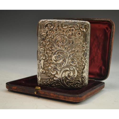 816 - A Victorian silver rounded rectangular aide memoir, embossed with flowers and scrolling foliage, hin... 