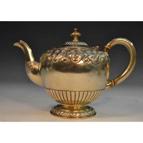 821 - A Victorian silver-gilt bachelor's tea service, comprising bullet shaped teapot, milk jug and sugar ... 