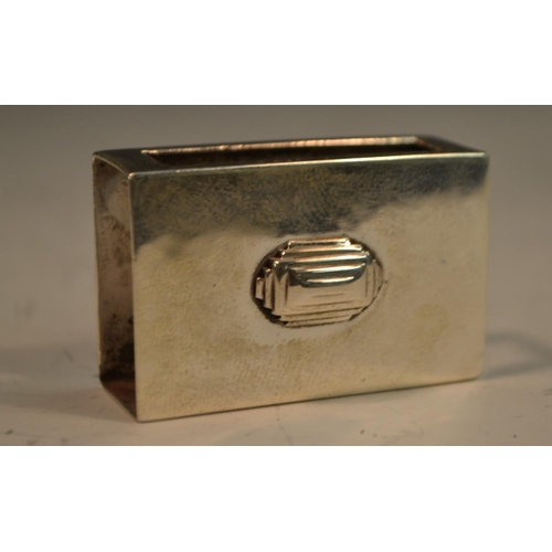 843 - An Art Deco silver matchbox sleeve, planished overall and applied with a geometric lozenge, 4.5cm wi... 