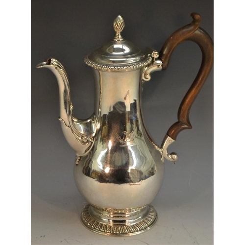 854 - An early George III silver baluster coffee pot, hinged domed cover with spiral-knop finial, scroll-c... 