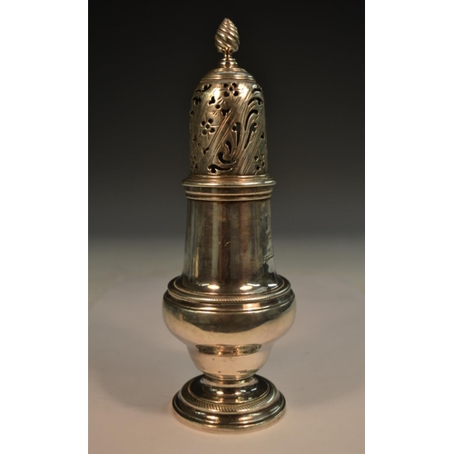 856 - An early George III silver pear shaped caster, spiral knop finial, pierced bell shaped cover, rope-t... 