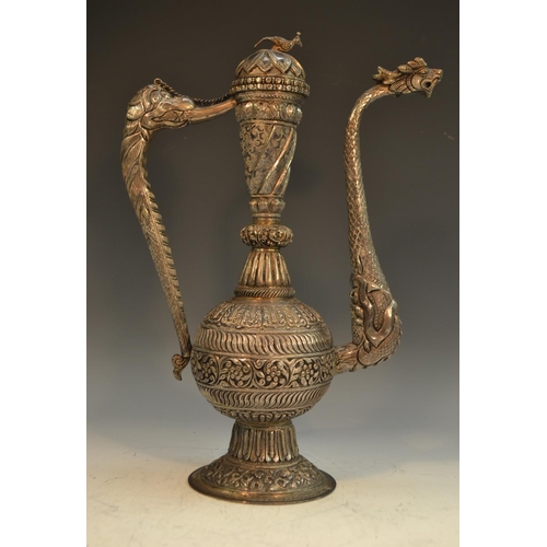 881 - An Indian Kutch silver libation ewer, of Mughal form, domed cover with restraining chain, dragon mas... 