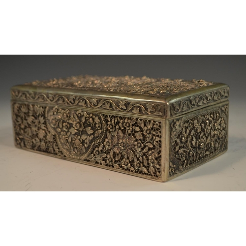 883 - An Indian/Neaplese silver rectangular cigar box, pierced and chased throughout with flowers, blossom... 