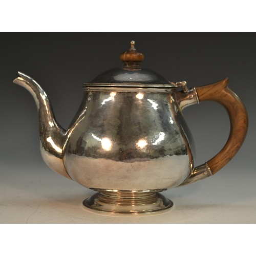 901 - Guild of Handicraft - an Arts and Crafts style silver teapot, hinged domed cover, skirted base, plan... 