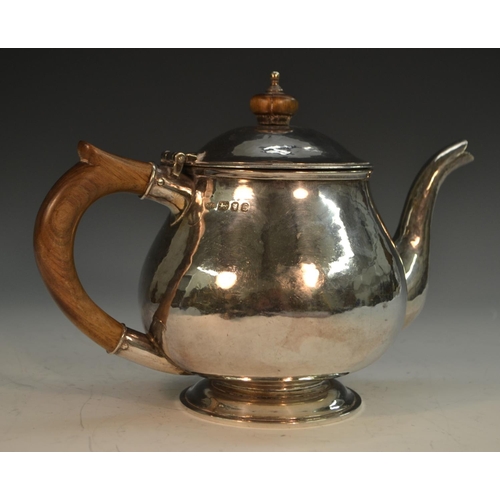 901 - Guild of Handicraft - an Arts and Crafts style silver teapot, hinged domed cover, skirted base, plan... 