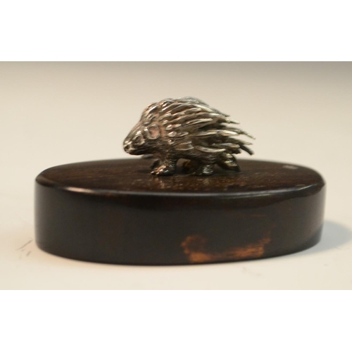 913 - Patrick Mavros - a silver model of a porcupine, hardwood base, 6cm wide