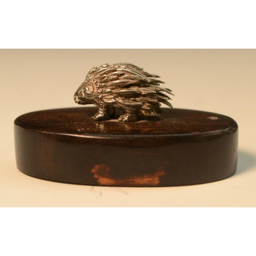 913 - Patrick Mavros - a silver model of a porcupine, hardwood base, 6cm wide